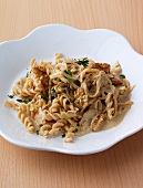 Noodles with nuts and herbs on plate