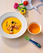 Coconut soup in serving dish and pumpkin mash in bowl