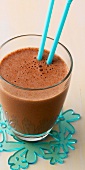 Close-up of banana chocolate smoothie in glass