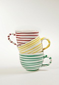 Striped cups in stack on white background