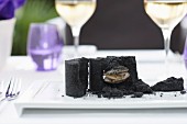 Sea truffles in black salt crust on tray