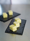 Olive oil jelly cubes on wooden board