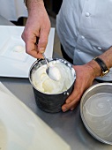 Scooping ice cream from bowl and putting on plate