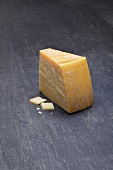 Grana padano cheese on gray surface