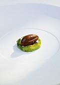 Brulee cream with avocado and frozen nutella almond on plate