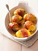 Stuffed potatoes with bacon and sauce on serving tray