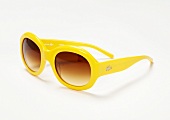 Close-up of yellow sunglasses on white background