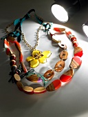 Wood chain with plastic surfaces and flower with rhinestone