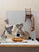 Various clothing and home accessories in creme on grey surface