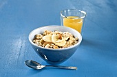 Nut muesli in bowl with juice glass