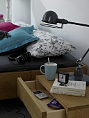 Bedside table with lamp, music player and headphones in bedroom