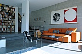 Living room with sofa, book shelf and concert block wall of Modern Town house