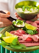 Close-up of Asian roast beef with remoulade Thai on plate