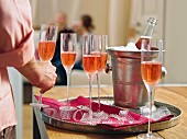 Glasses of rosé champagne on a tray