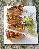 Onion tart with bacon and egg on serving plate