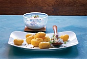 Sour cream potatoes with pickles in serving dish