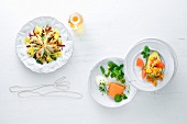 Rabbit salad, watercress salad and avocado salad on three plates