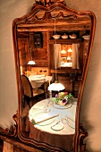Reflection in mirror of set table at Restaurant La Stua de Michil, South Tyrol, Italy