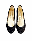 Close-up of black ballerinas suede on white background