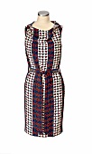 Close-up of silk dress with graphic pattern and cowl neck on mannequin