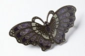 Close-up of butterfly shaped barrette on white background