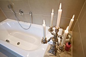 Swedish style bathroom with bathroom and lit candles on candle stand