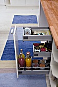 Bottles and jars in open kitchen drawer