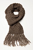 Chunky knit scarf with fringe on white background