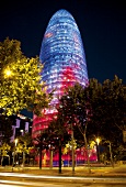 Colourful glass facade of Torre Agbar skyscraper at night in Barcelona, Spain