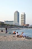 People relaxing on Barceloneta beach in Barcelona, Spain