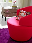 Pink contemporary swivel arm chair and romantic stool on purple mat
