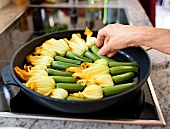 Close-up of zucchini flowers being cooked in pan