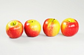 Close-up of four apples on white background