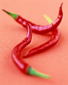 Close-up of three red chilly peppers