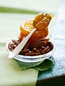 A spoonful of marmalade on candied orange slices with nuts