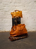 Different travel bag made from recycled PET bottles, against white wall