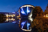 Symmetrical reflection of Atlantic Hotel Universum at night, Bremen, Germany