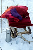 Blankets kept on sledge with thermos at side on snow