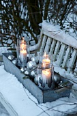 Zinc Planter with lanterns and Christmas balls on garden bench
