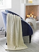 Knitted woollen stoll on armchair