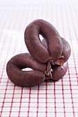 Blood sausage on red and white checked tablecloth