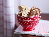 A bowl of chocolate almond biscuits and hazelnut biscuits