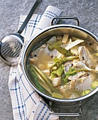 Fish stock with carcass in casserole