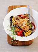Mediterranean vegetables with chicken wings in serving dish