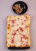Walnut pieces beside bacon and pear quiche