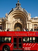 Tourist in red bus passing from Petit Palais, Paris, France