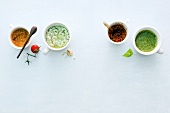 Four different sauces for pasta in cups, overhead view