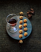 Pieces of chocolate, gorgonzola chocolate truffle and glass of port wine on tray