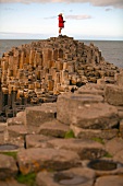Man standing on Giant's Causeway at Antrim coast, Ireland