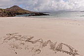 Close-up of Ireland written on sand at Ring of Kerry Inch Beach, Ireland